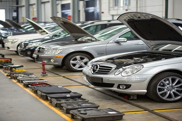 A lineup of various Mercedes-Benz models in a warehouse setting