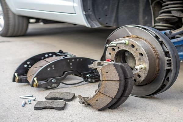 A comparison showing the larger surface area of a brake shoe versus a brake pad