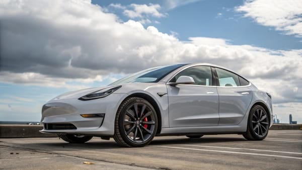 A 2018 Tesla Model 3 accelerating on an open road.