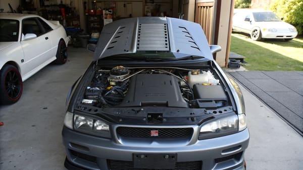 A car with aggressive double hood scoops