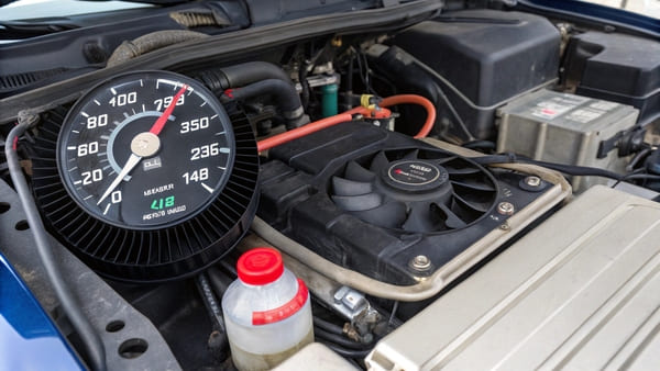An OBD2 scanner showing live engine coolant temperature data