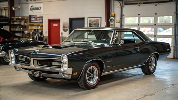 A Pontiac GTO on the road, showcasing its powerful stance