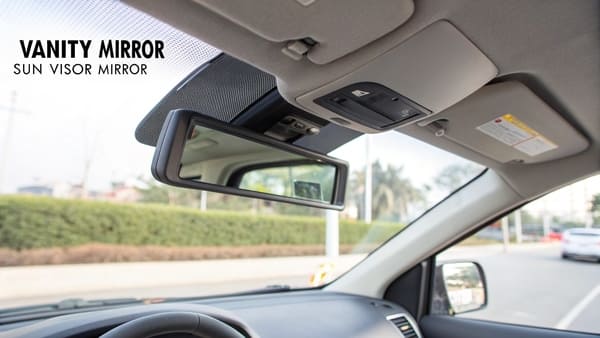 A close-up of a car's sun visor with the flip mirror open