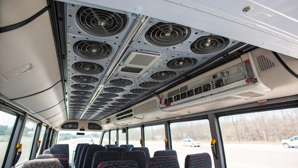 A basic city bus without visible signs of a large AC unit