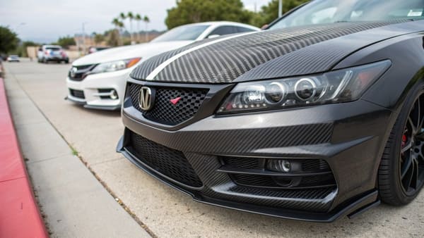 a comparison of a dry carbon fiber car hood and a wet carbon fiber car spoiler
