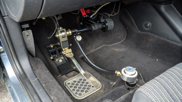 A close-up of a clutch master cylinder installed in a car's engine bay.