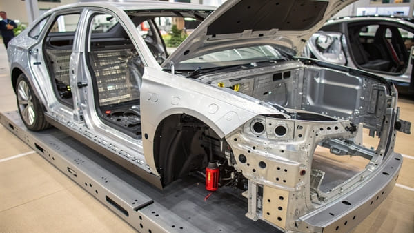 A close-up shot of different car body materials like steel, aluminum, and plastic.