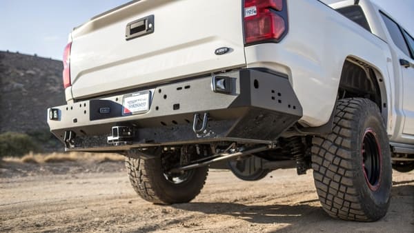 A rugged black rear steel bumper installed on an off-road truck